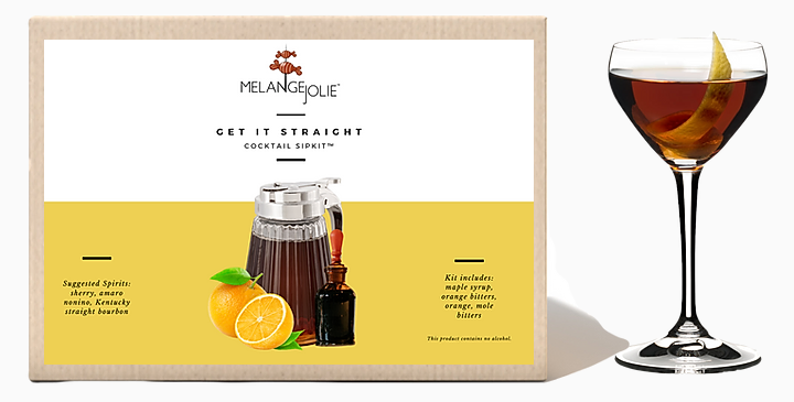 Mélange Jolie Get It Straight Cocktail SipKit™ featuring a glass, bar spoon, cocktail sticks, Vermont maple syrup, dehydrated oranges, navel orange, and mole bitters.